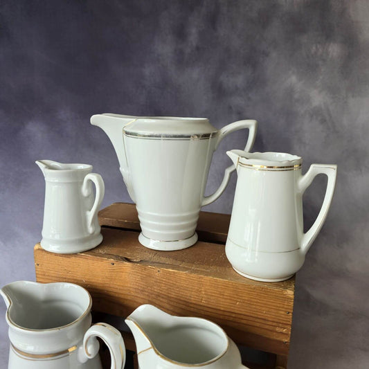 Set aus 5 antiken Milchkännchen